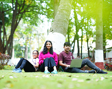 Students sitting under tree at Ebenezer International School Bangalore